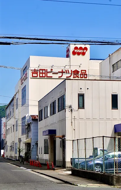 「吉田ピーナツ食品」の文字が並ぶ、大きな会社の建物