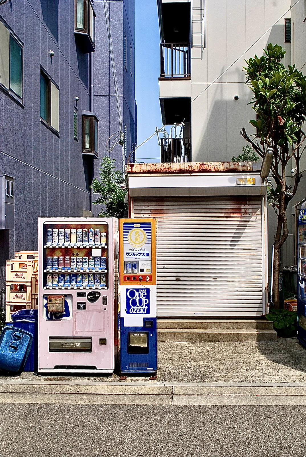 お酒の自動販売機と、さびたシャッターの小さな建物