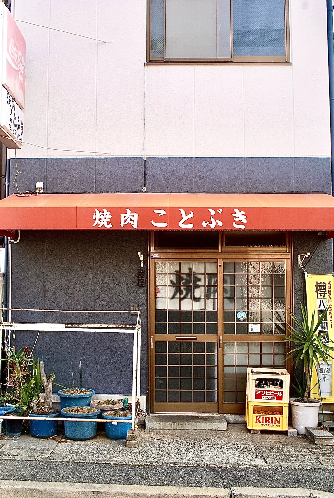 「焼肉 ことぶき」の日よけと、格子戸の入口