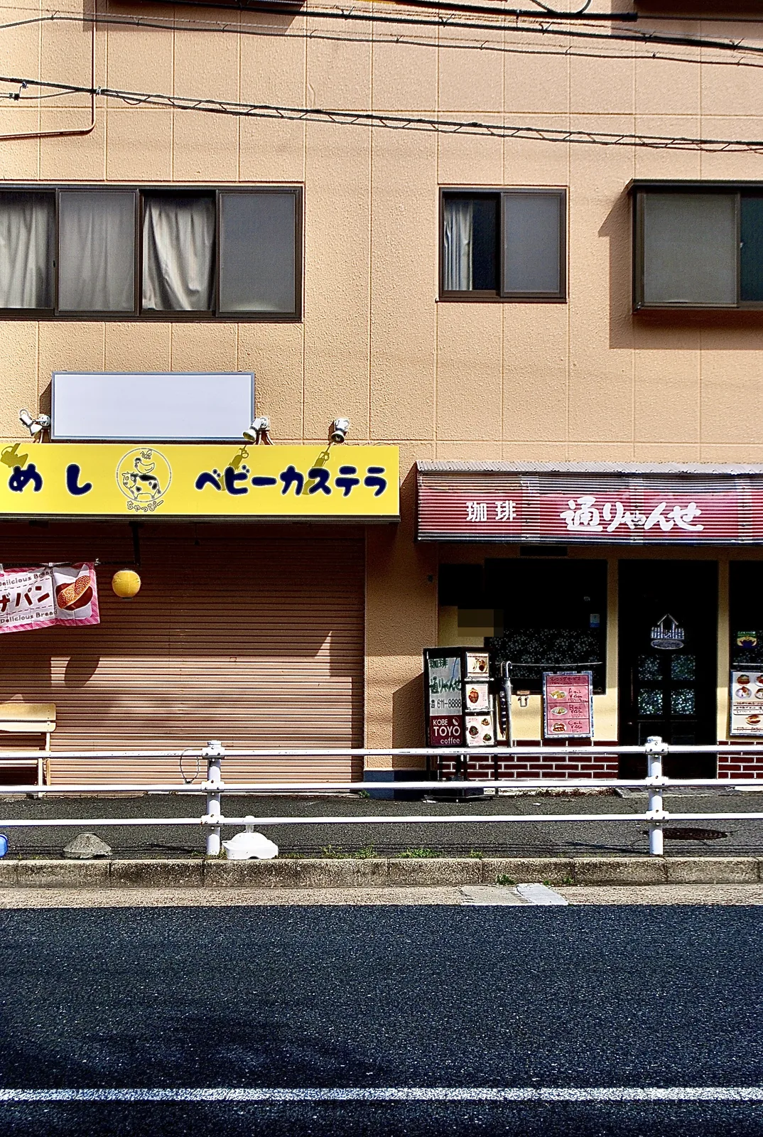 黄色い看板のベビーカステラの店と、喫茶「通りゃんせ」の並ぶ通り